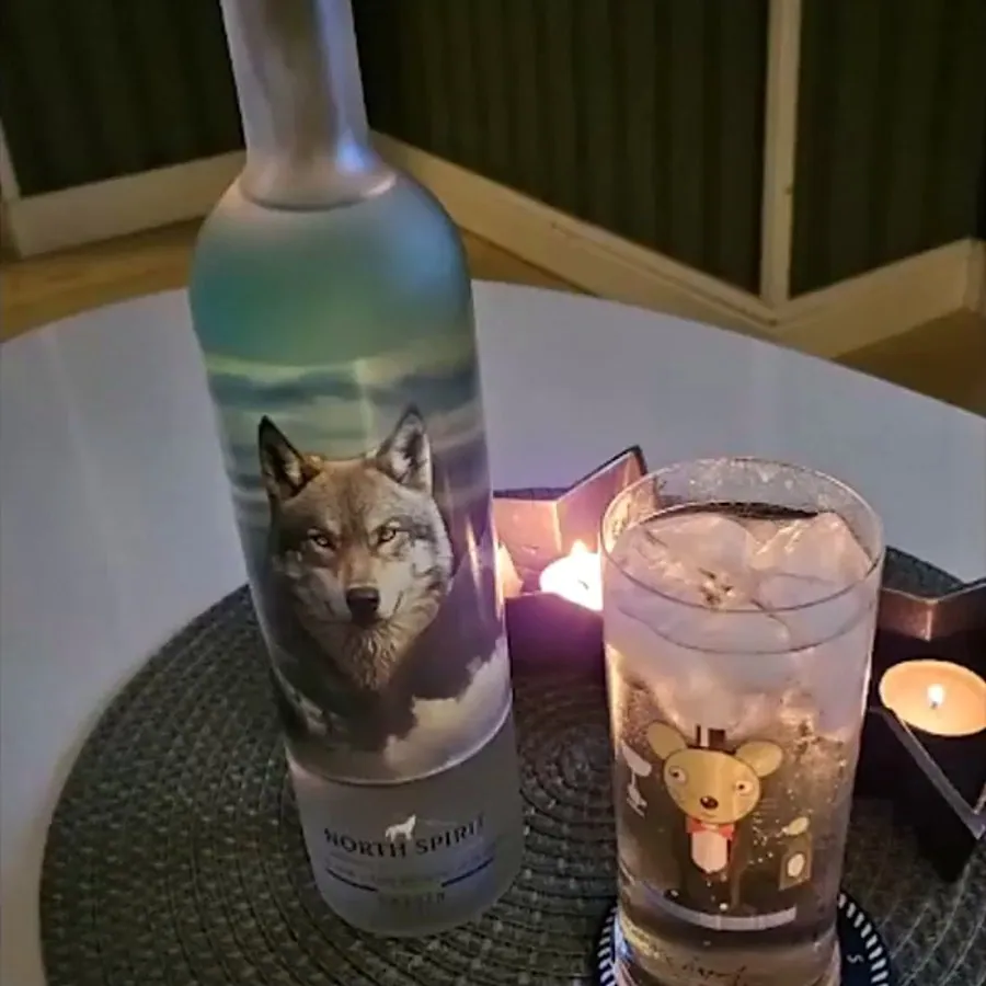 A bottle and a glass on a tray